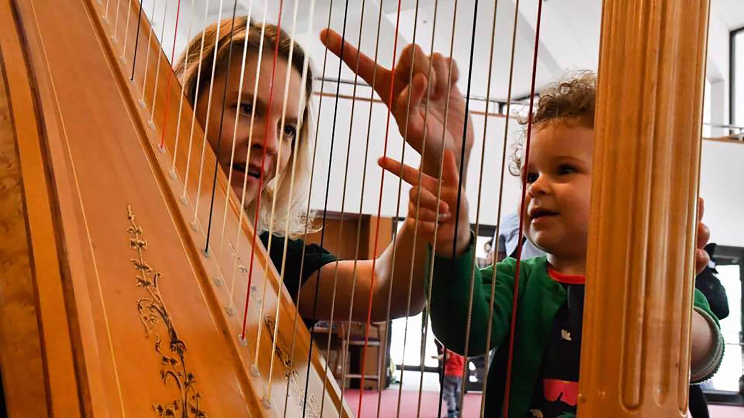 Kid playing with Harp