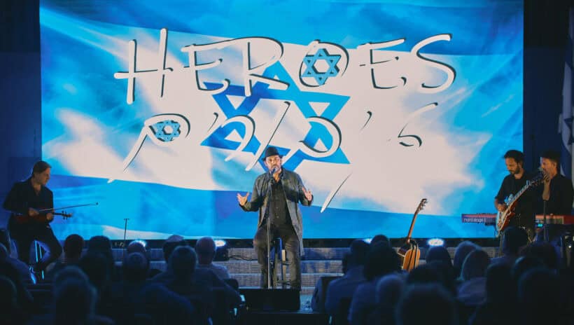 project heroes concert on stage in front of israeli flag