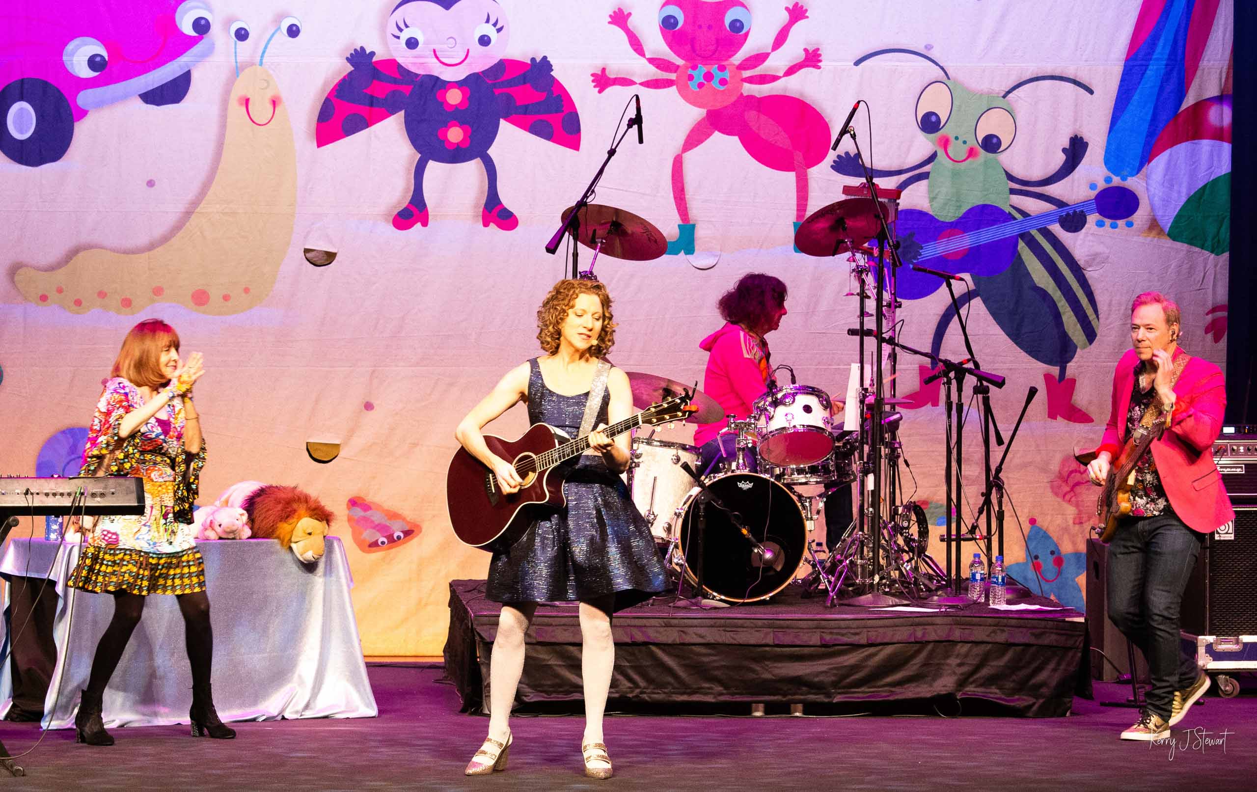 adult musicians performing on stage for kids.