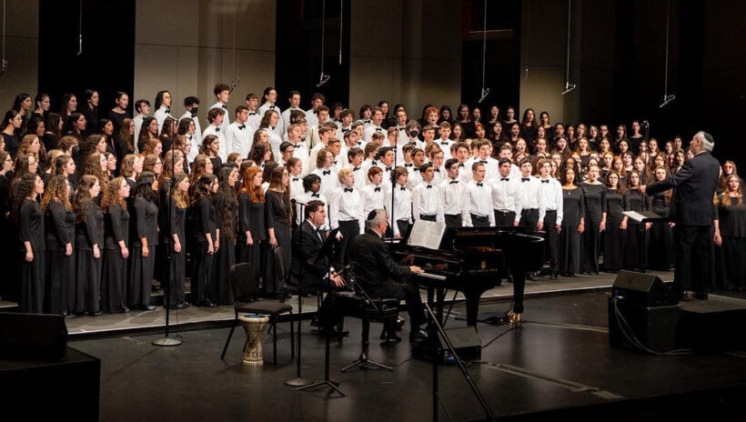 teen choir group performing on stage